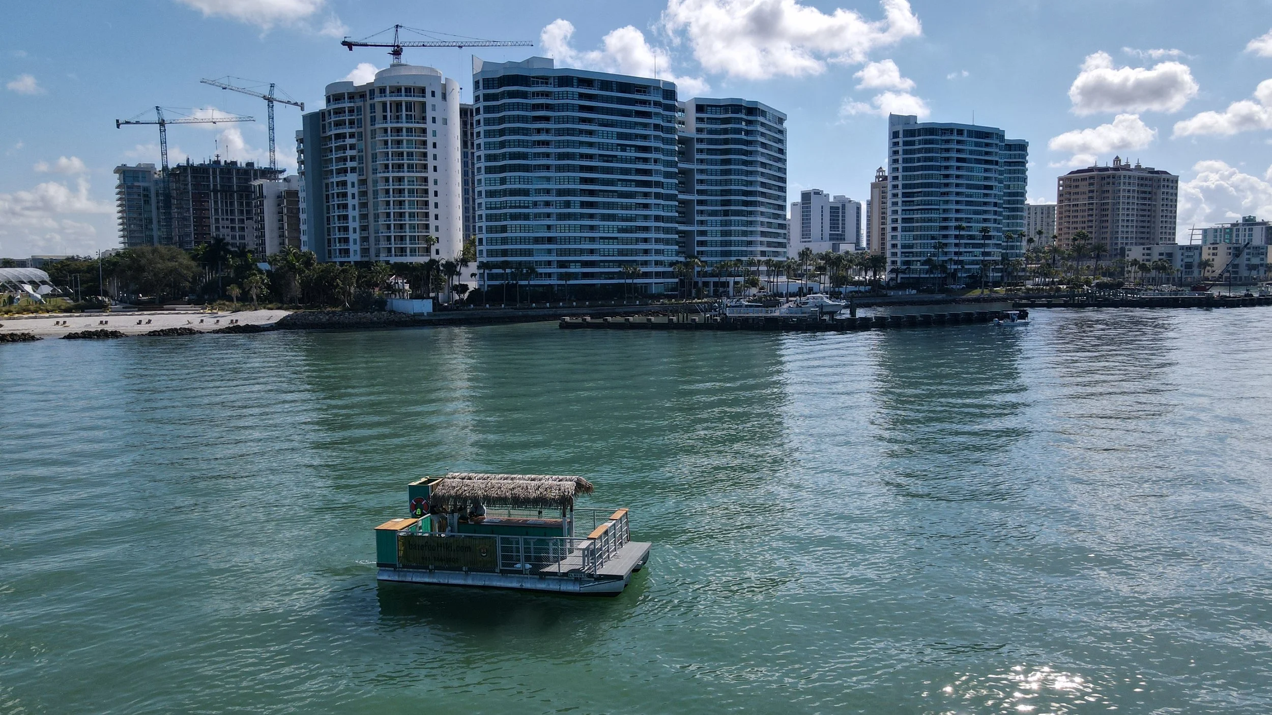 Tiki boat cruising Sarasota waterfront